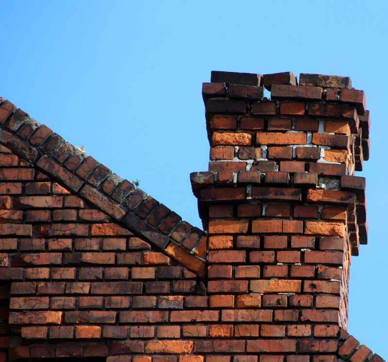 Damaged chimney on an Evanston home showing cracks and missing mortar